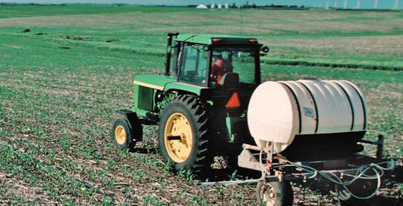 Fertilizer applied in field by tractor